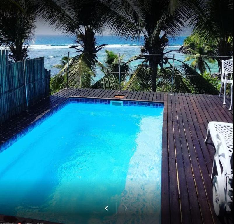 a swimming pool with a view of the beach at South Point Villas Cerf Island in Cerf Island