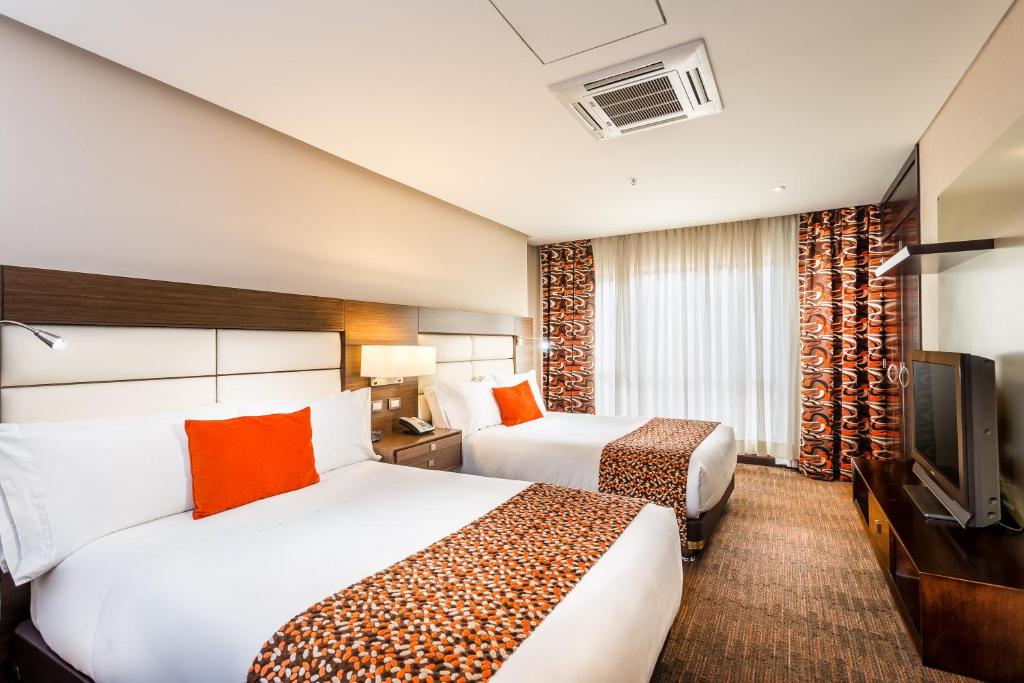 Postel nebo postele na pokoji v ubytování Casa Dann Carlton Hotel & SPA