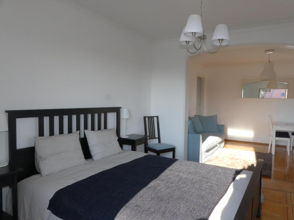 a bedroom with a black and white bed and a desk at Au Bonheur des Iris in Rolle