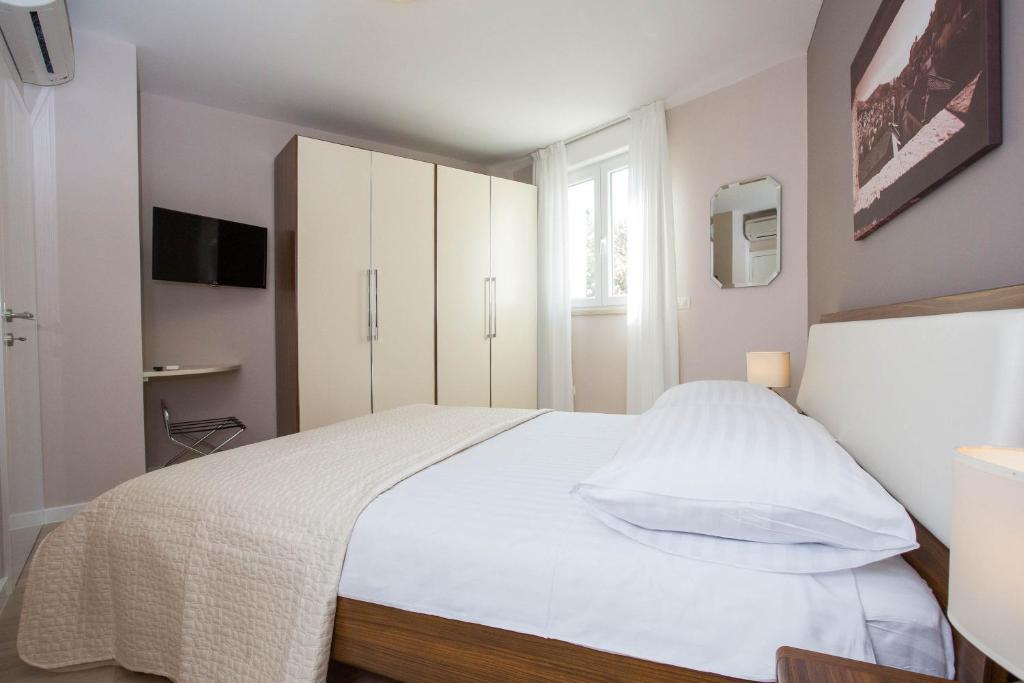 Postel nebo postele na pokoji v ubytování Moderna Lapad