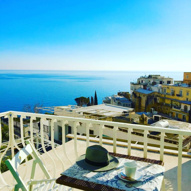 a table and chairs on a balcony with a view of the ocean at Hotel Villa Delle Palme in Positano in Positano