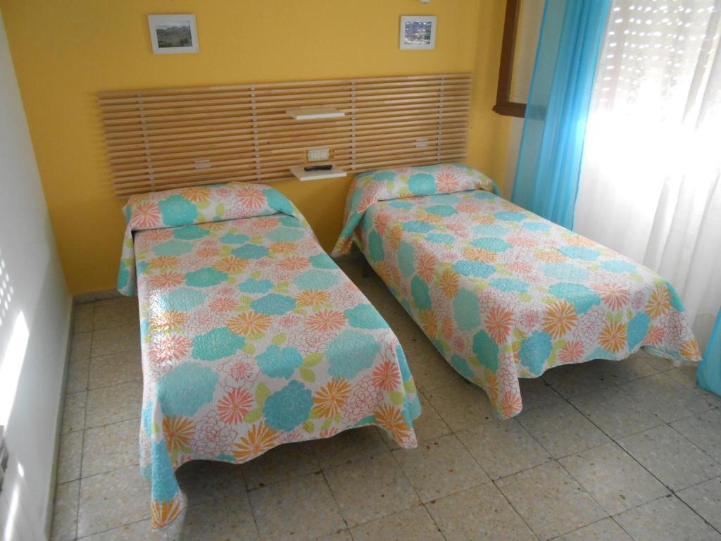 Postel nebo postele na pokoji v ubytování Hostal Avenida