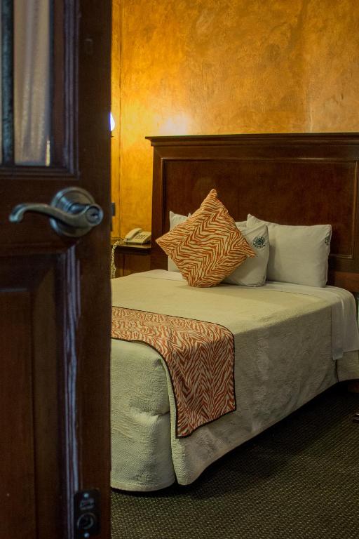 Postel nebo postele na pokoji v ubytování Hotel Historia