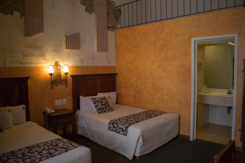 Postel nebo postele na pokoji v ubytování Hotel Historia