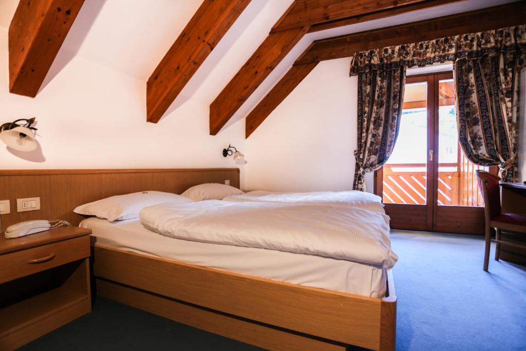 Postel nebo postele na pokoji v ubytování Hotel Fortini