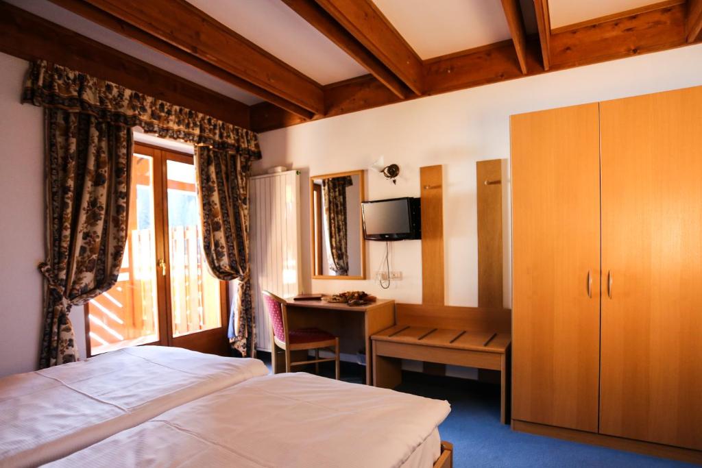 Postel nebo postele na pokoji v ubytování Hotel Fortini