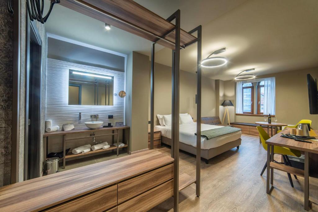 a bedroom with a canopy bed and a bathroom at 9 stanze - Boutique Rooms in Trieste