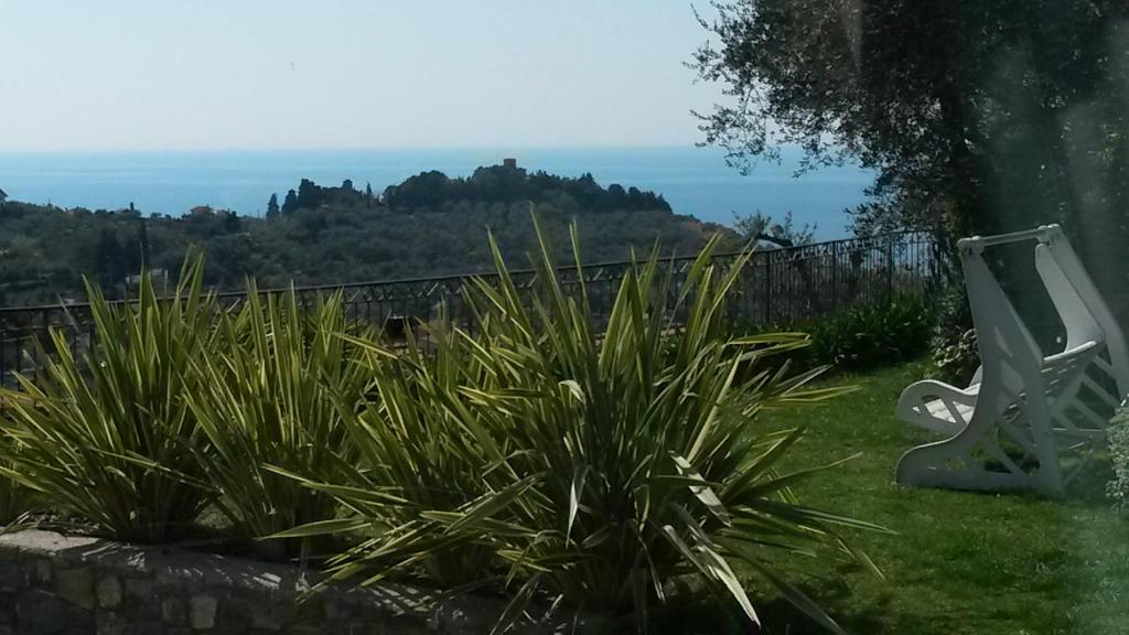 a view of the ocean from a garden at B&B Villa Isabella in Imperia