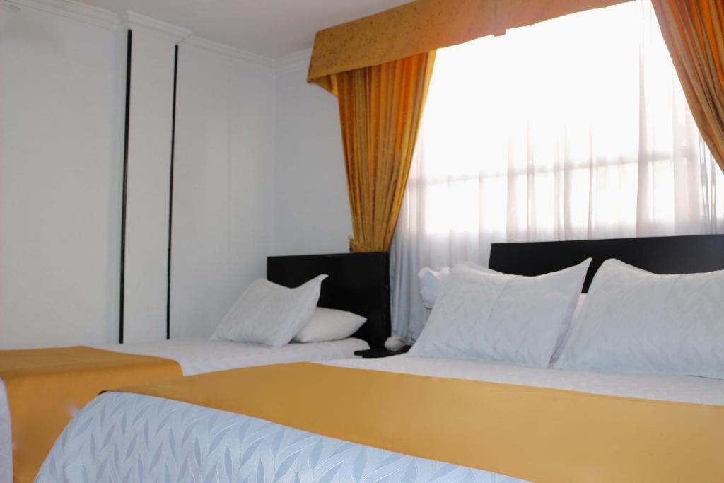 Postel nebo postele na pokoji v ubytování Hotel Ferrovial Corferias