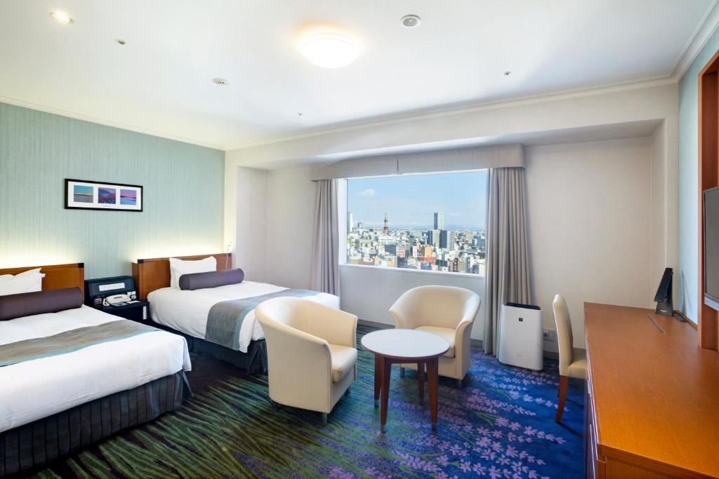 Postel nebo postele na pokoji v ubytování Sapporo Excel Hotel Tokyu