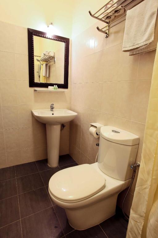 a bathroom with a toilet and a sink at Tuna Bay Island Resort in Perhentian Islands
