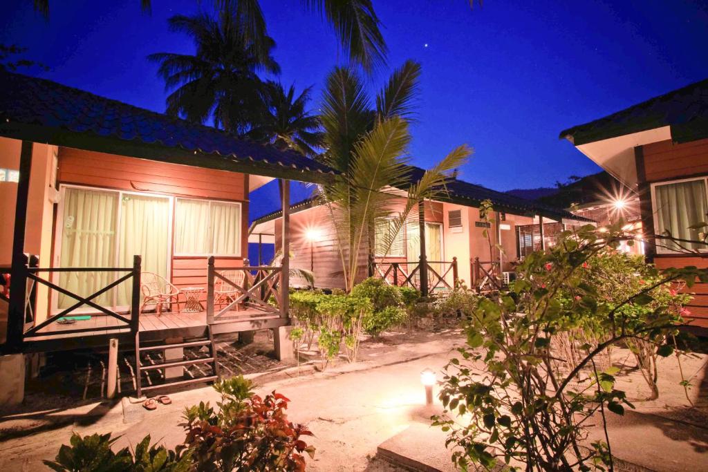 a row of houses at night with lights at Tuna Bay Island Resort in Perhentian Islands