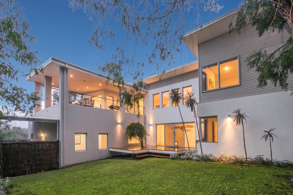 a large white house with a yard at Calm Waters in Dunsborough