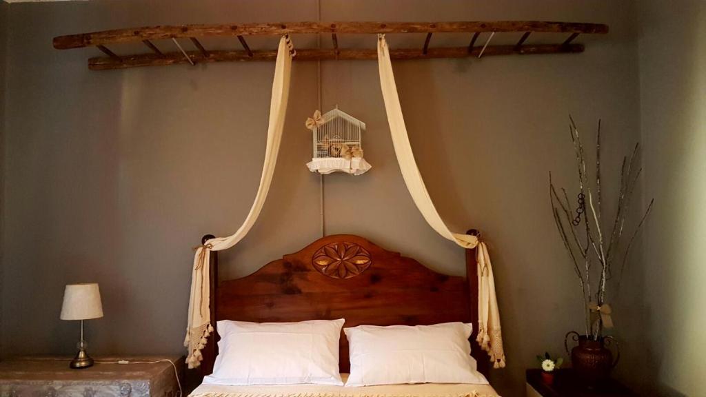 a bedroom with a bed with two hanging hammocks at La mia casa di campagna in Rovieto