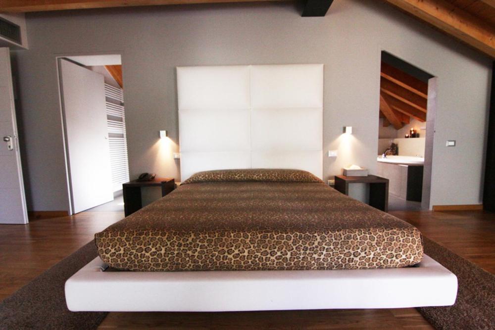 a bedroom with a large bed in a room at Ex-L in Fiume Veneto