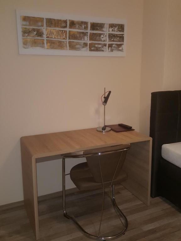 a desk in a room with a lamp on it at Hotel-Residenz Oberurseler Hof in Oberursel