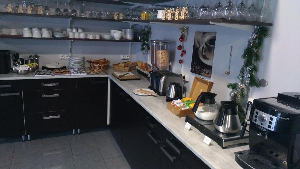 a kitchen with a counter with a coffee maker and a microwave at Hotel Bleu Azur in Argelès-sur-Mer