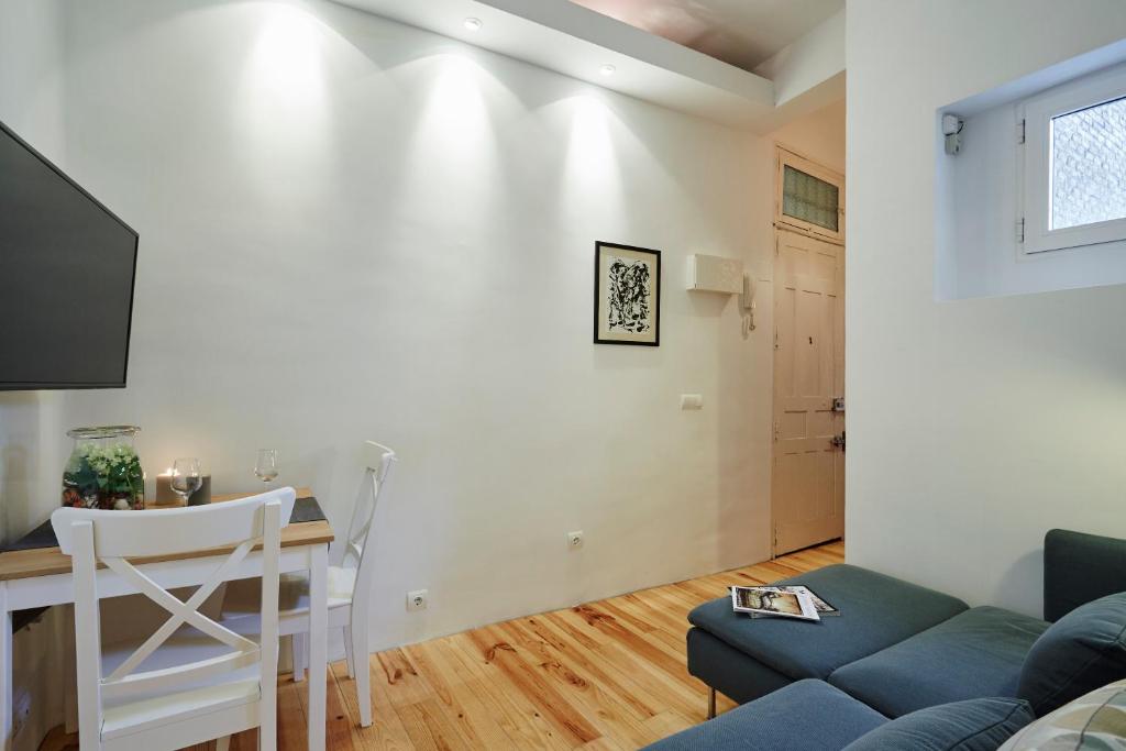 a living room with a blue couch and a table at LEEWAYS APARTMENT in MANCEBOS in Madrid