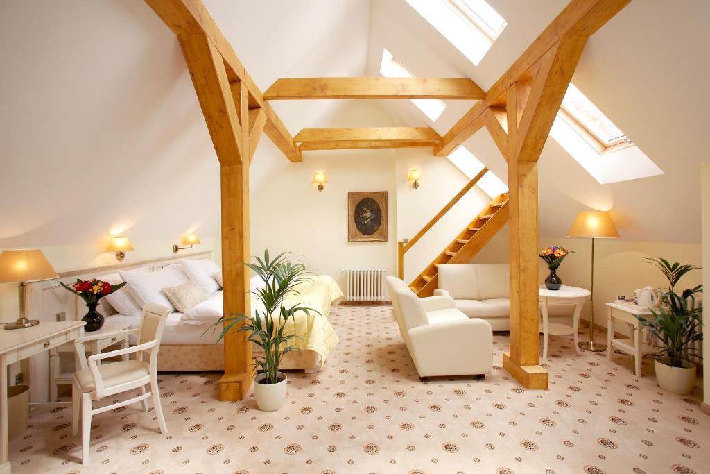 a living room with a white couch and wooden beams at Hotel Metamorphis in Prague