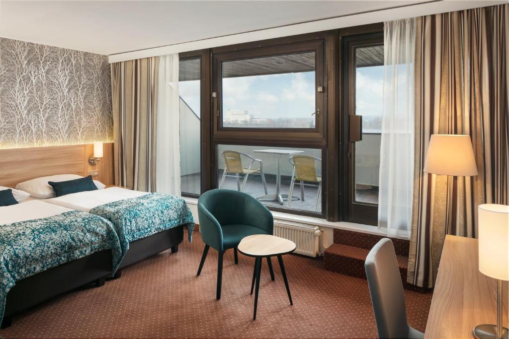 Postel nebo postele na pokoji v ubytování Congress & Wellness Hotel Olsanka