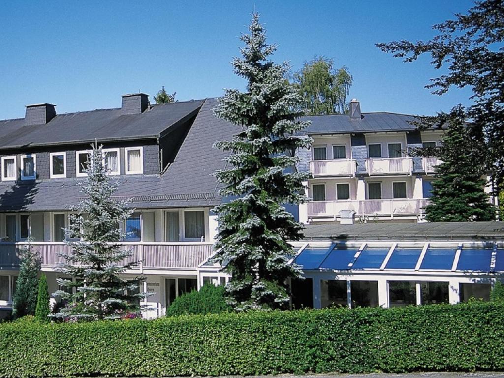 ein großes weißes Haus mit Bäumen davor in der Unterkunft Horn's Gästehaus in Bad Steben