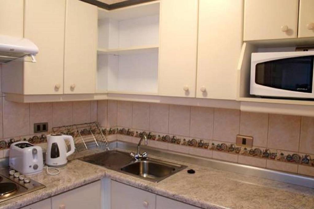Kuchyň nebo kuchyňský kout v ubytování Apart Hotel Carampangue