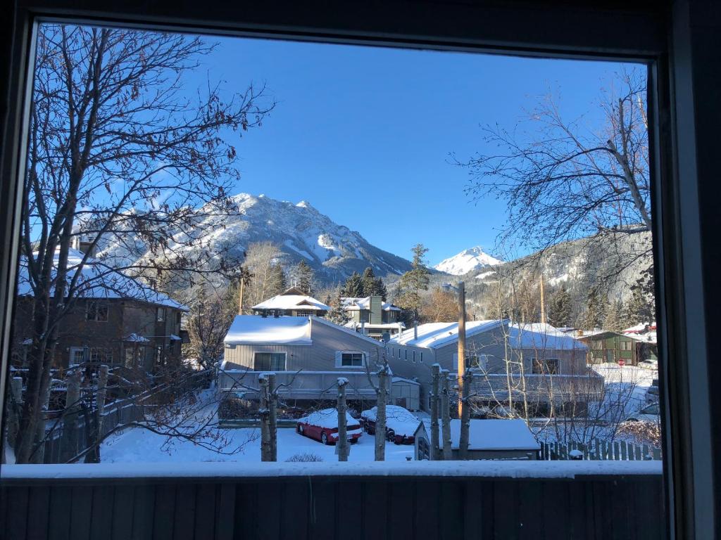 a view of a snow covered mountain from a window at Mountain View Bed & Breakfast in Banff
