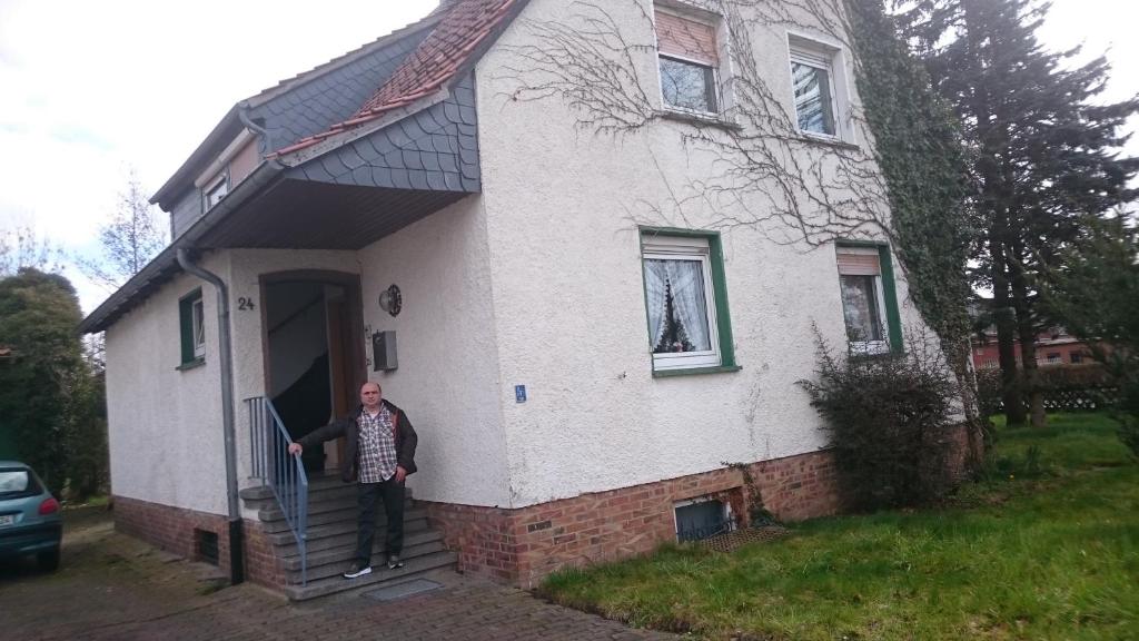 a man standing in the doorway of a house at Gastzimmer in Salzgitter