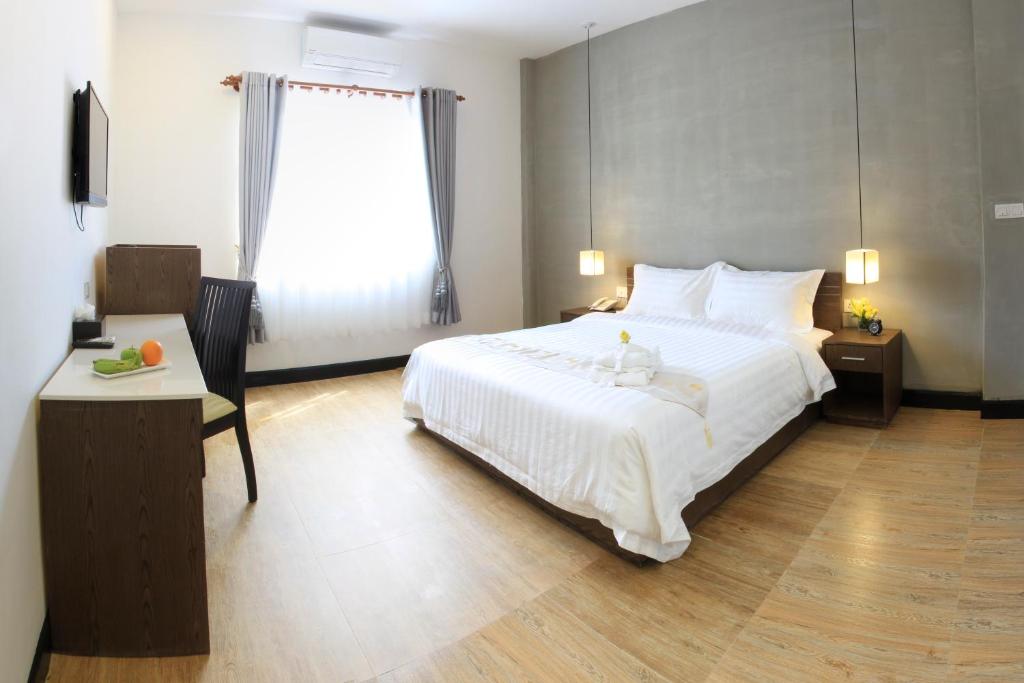 Postel nebo postele na pokoji v ubytování Asiban Quay Boutique Hotel