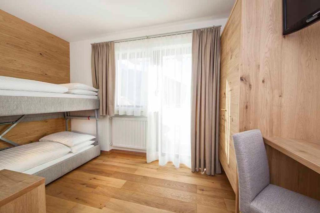Postel nebo postele na pokoji v ubytování Hotel Garni Morene