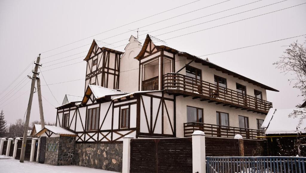 a large house with snow on the top of it at Лыжа in Zelenaya Polyana