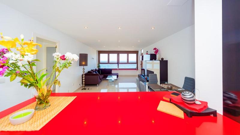 a living room with a red table and a red rug at La Mata Beach Apartment in La Mata
