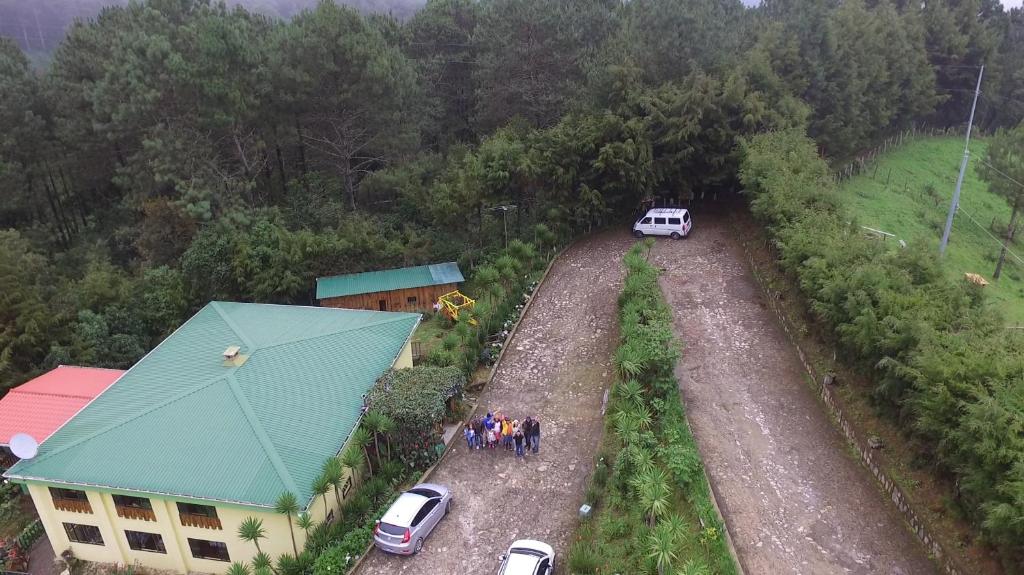 an aerial view of a group of people standing on a dirt road at Alla Arriba in Las Cruces