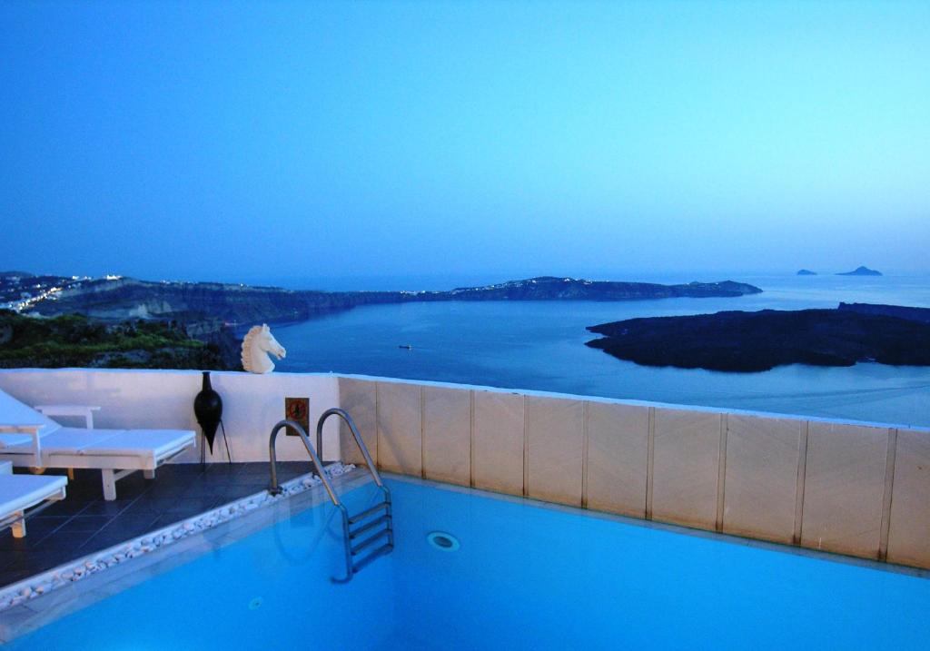 a swimming pool with a view of the ocean at Aeolos Art & Eco Suites Adults Only in Imerovigli