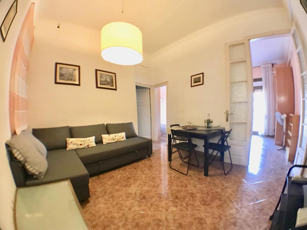 a living room with a couch and a table at Plaza España Central Apartment in Barcelona