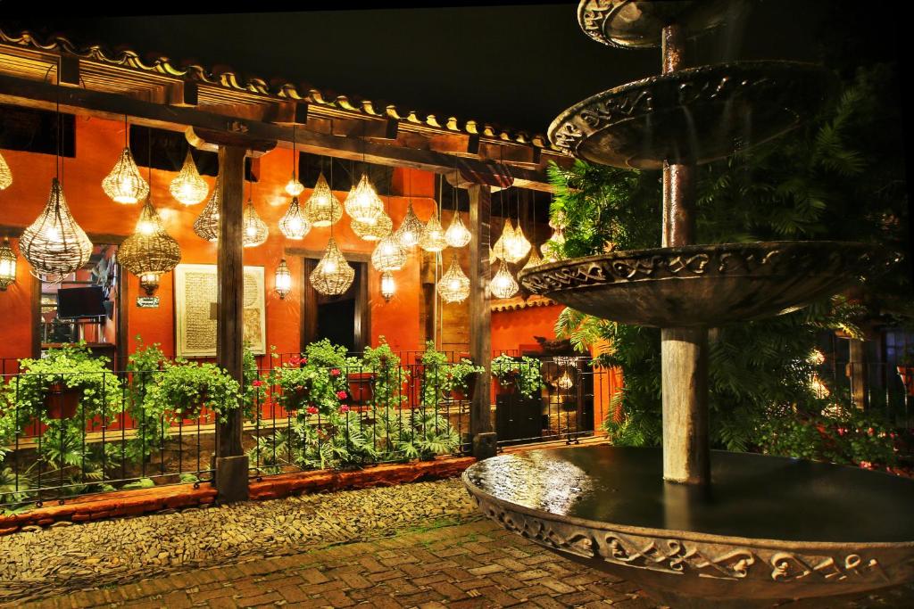 a fountain in front of a building with lights at Hotel La Casa de Maty in Tapalpa