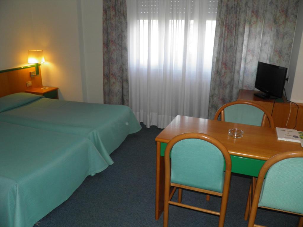 Postel nebo postele na pokoji v ubytování Hotel Ramoverde