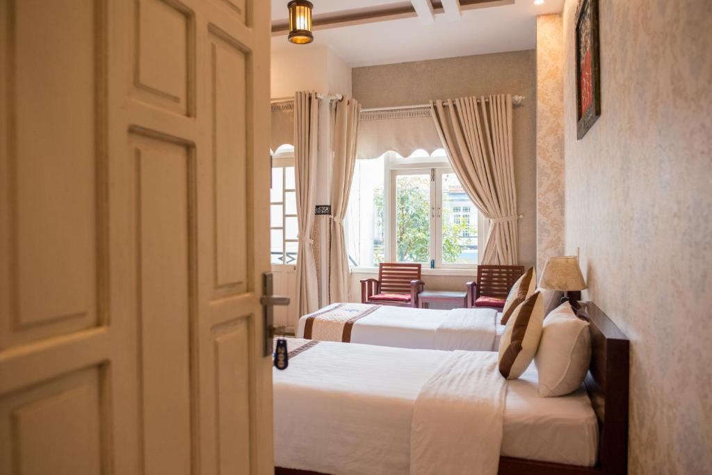 Postel nebo postele na pokoji v ubytování Hoi An Ngo Homestay