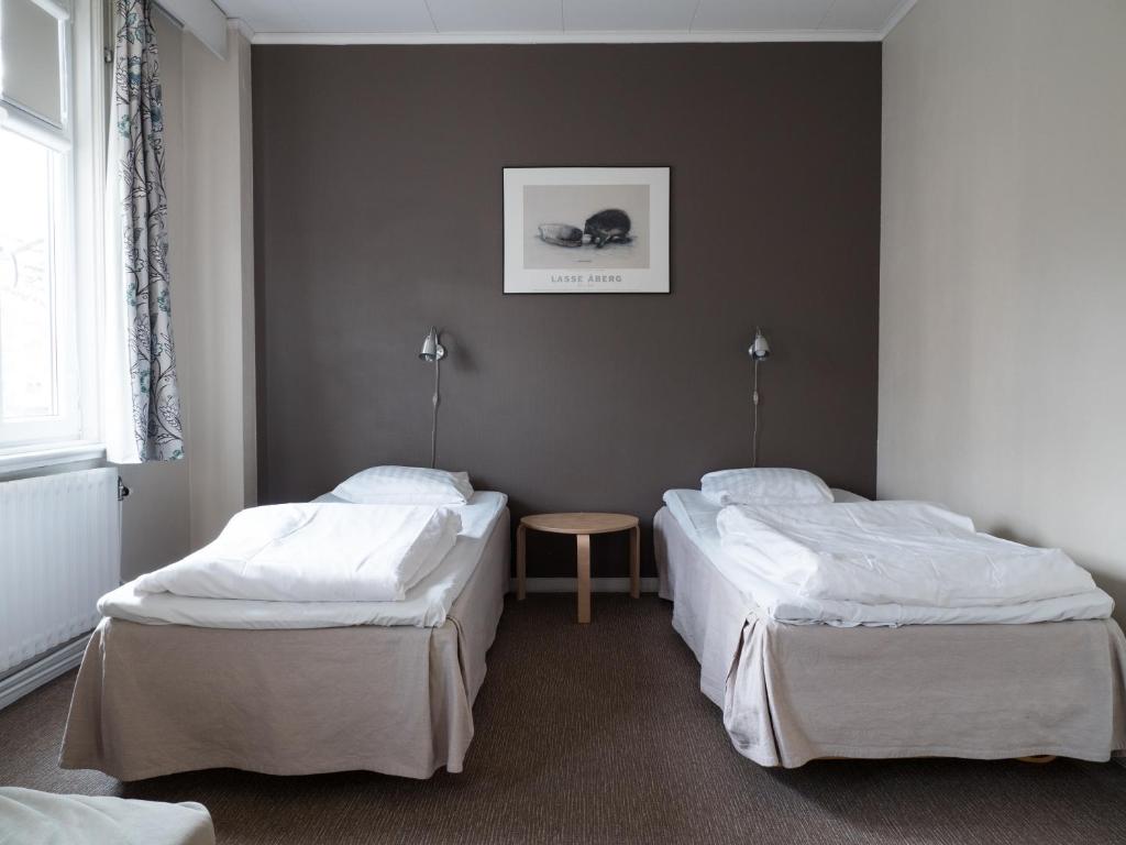 Postel nebo postele na pokoji v ubytování Hotel Åberg Centralhotellet