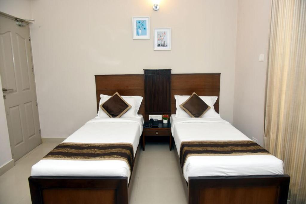Postel nebo postele na pokoji v ubytování Hotel Pearl International
