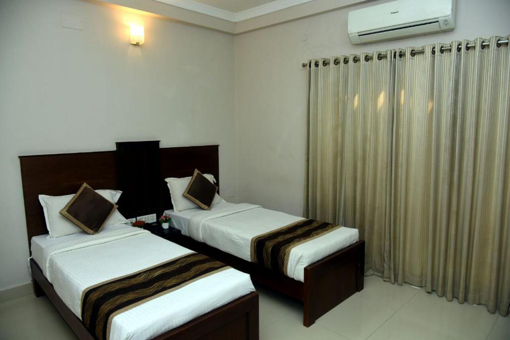 Postel nebo postele na pokoji v ubytování Hotel Pearl International