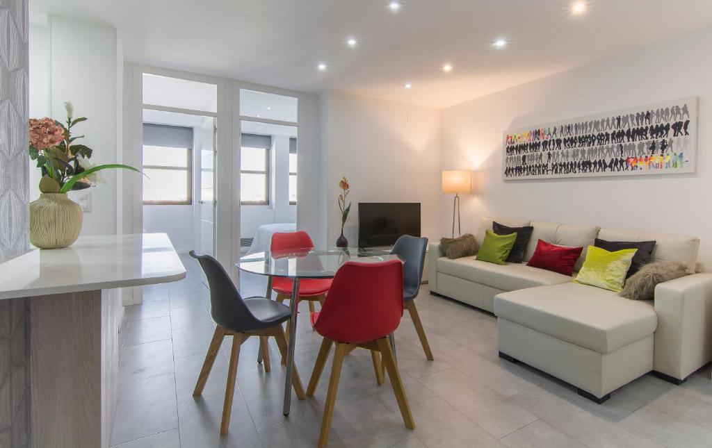 a living room with a table and chairs and a couch at Plaza España & Gran Via 2BD 1BTH in Madrid