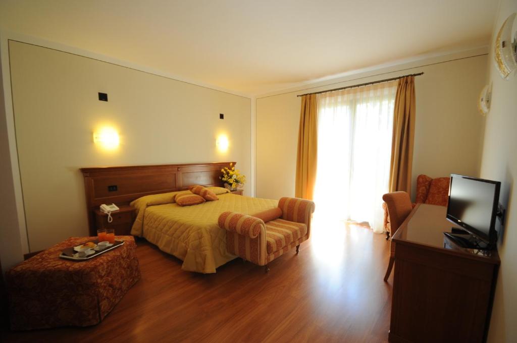 Posteľ alebo postele v izbe v ubytovaní Hotel Panoramic Montepulciano