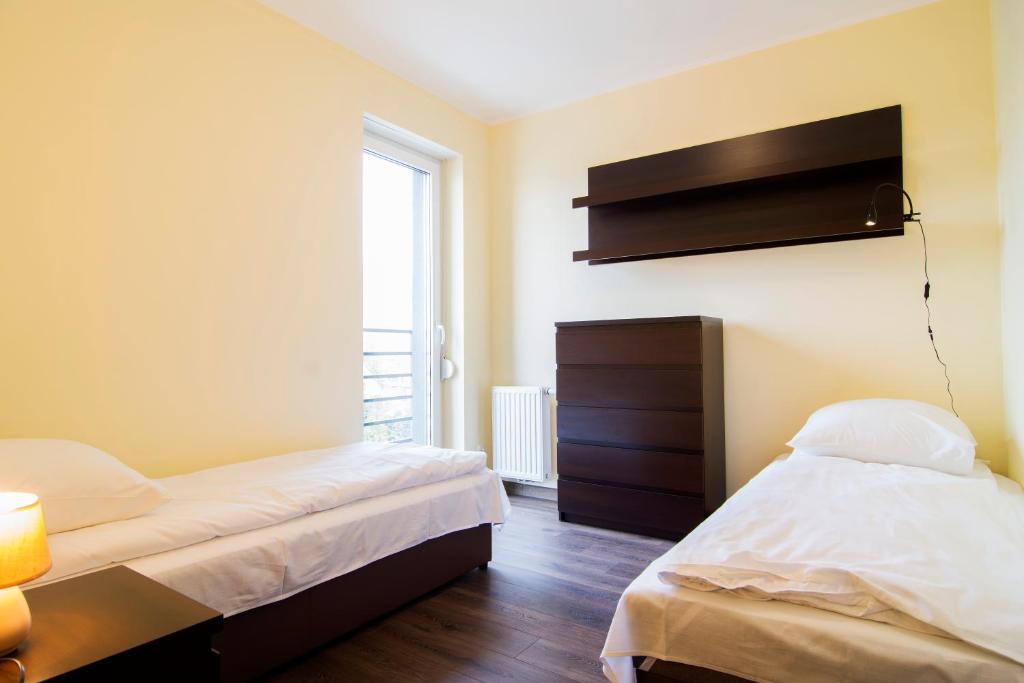 Posteľ alebo postele v izbe v ubytovaní Apartamenty Sun & Snow Ustroń Przy Rynku