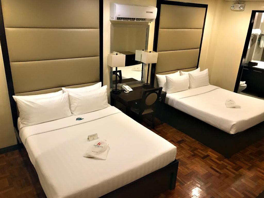 Postel nebo postele na pokoji v ubytování Jinjiang Inn - Boracay Station 1