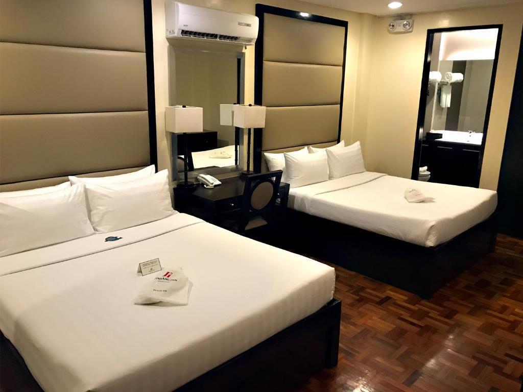 Postel nebo postele na pokoji v ubytování Jinjiang Inn - Boracay Station 1