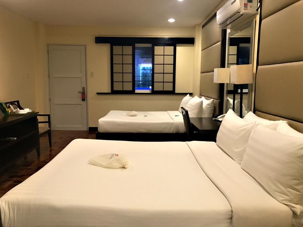 Postel nebo postele na pokoji v ubytování Jinjiang Inn - Boracay Station 1