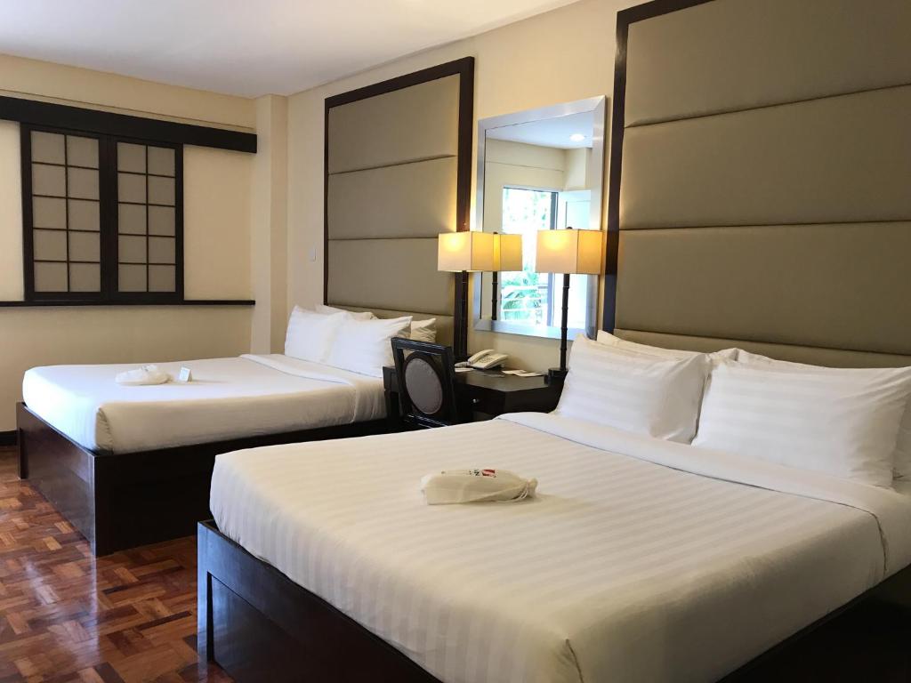 Postel nebo postele na pokoji v ubytování Jinjiang Inn - Boracay Station 1