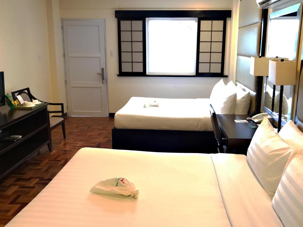 Postel nebo postele na pokoji v ubytování Jinjiang Inn - Boracay Station 1