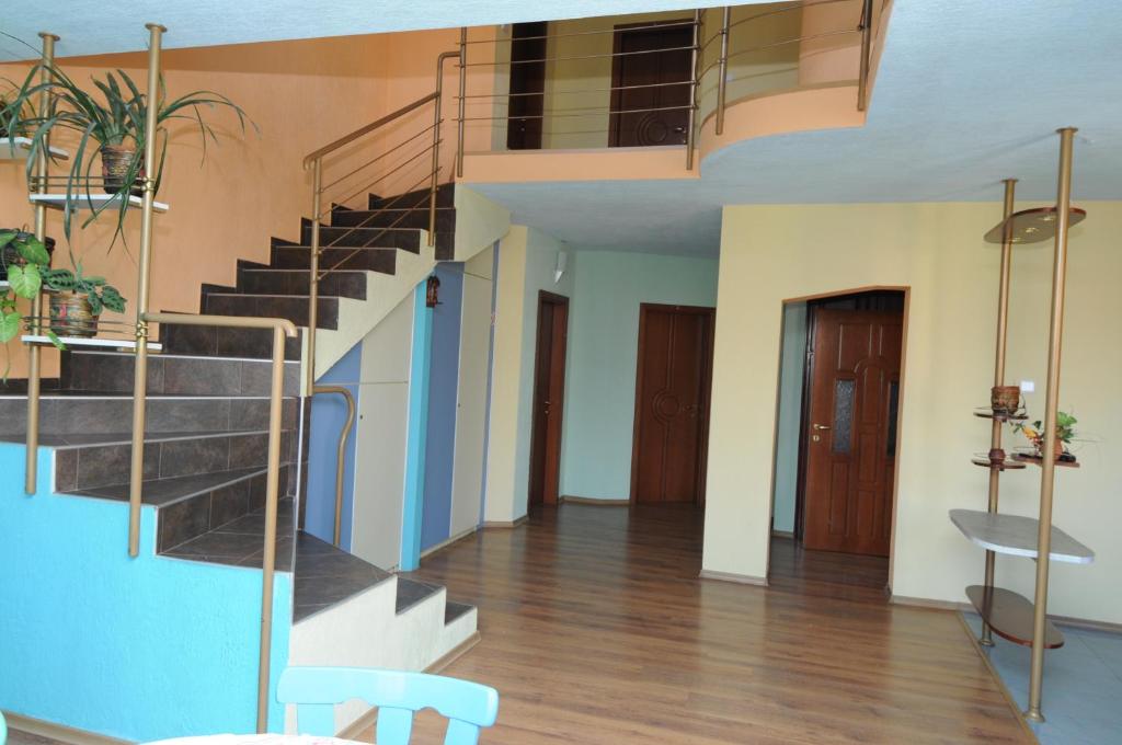 a living room with a spiral staircase in a building at Family Hotel Studio in Sandanski